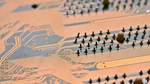 A high-resolution macro shot of a yellow printed circuit board (PCB), showing Stock Footage 330486148