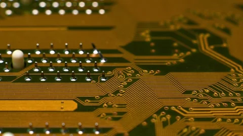 A high-resolution macro shot of a yellow printed circuit board (PCB), showing Stock Footage 330486256