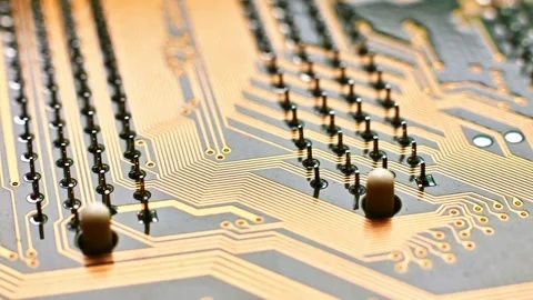 A high-resolution macro shot of a yellow printed circuit board (PCB), showing Stock Footage 330486276