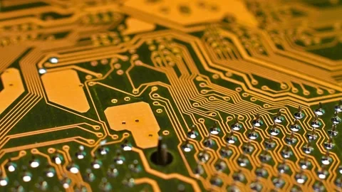 A high-resolution macro shot of a yellow printed circuit board (PCB), showing Stock Footage 330486309