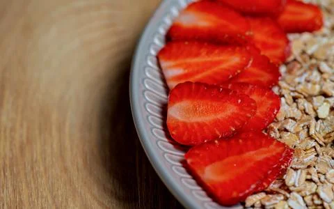 High resolution: Oat flakes with sliced straweberries Stock Photos