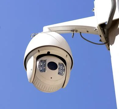 High resolution oval shape video surveillance camera on the street on blue .. Stock Photos
