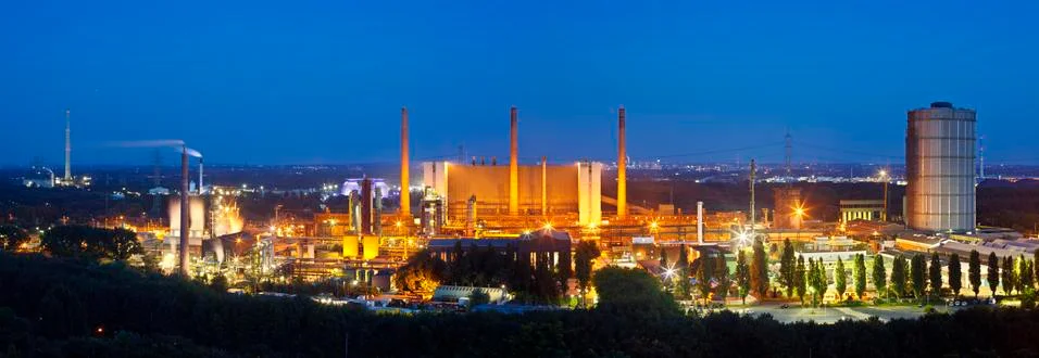 High resolution panoramic shot of a large coking plant with night blue sky. Stock Photos