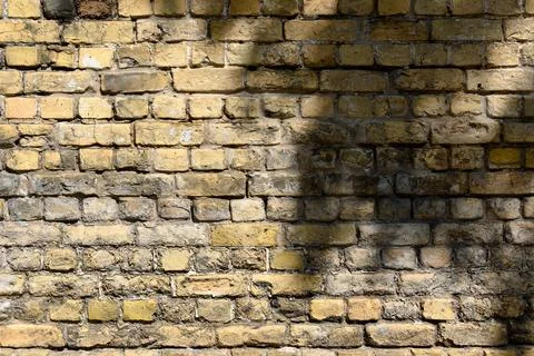 High resolution texture of a yellow brick wall background in the countryside  Stock Photos