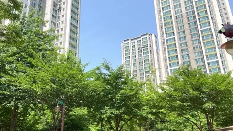 A high-rise apartment complex with lush trees and parks Stock Footage 244052653