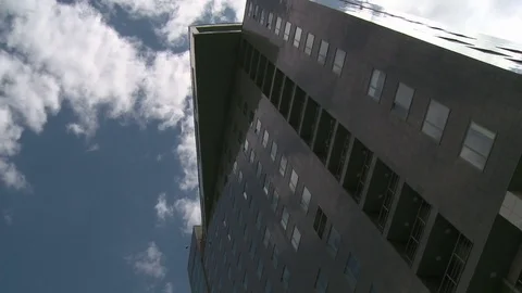 High rise building and clouds floating in the sky Stock Footage 79727541