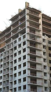 A high rise building is captured during its construction phase, showcasing an Stock Photos