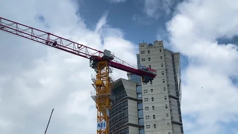 High rise building constructing with yellow tower crane in Dhaka, Bangladesh - Stock Footage 334582680