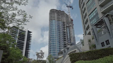 High rise building construction. Active crane.  Clouds sweep above.  Timelapse Video stock 253766413