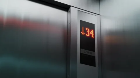 High-rise building elevator descending, floor numbers displayed on control panel Stock Footage 334723137