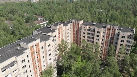 High-rise building overgrown with trees of the city of pripyat Stock-Footage 194429517