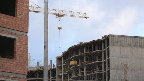 A high-rise building under construction. Construction crane and workers Stock Footage 84323164
