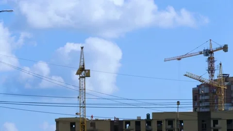 High-rise building under construction with working cranes Stock Footage 132996324