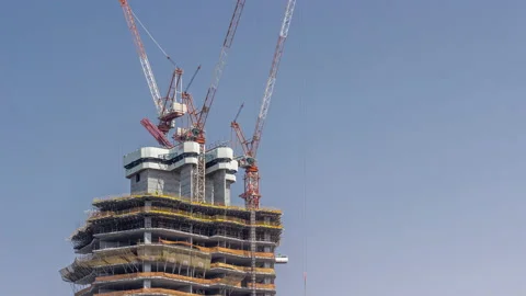 High-rise building under construction. The site with cranes against blue sky Stock Footage 166446887