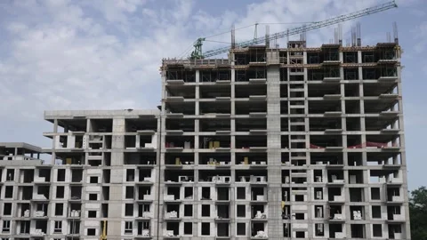 High-rise building under construction with concrete frames and crane Stock-Footage 304355491