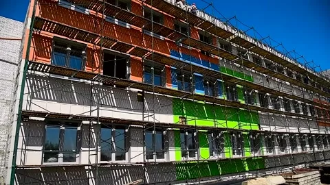 High-rise building under construction with scaffolding Stock Footage 305988569