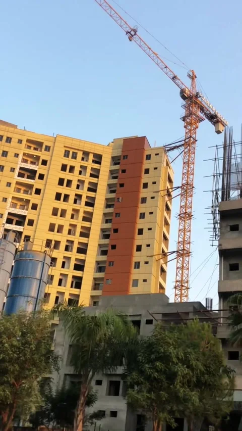 High-Rise Building Under Construction with Tower Crane and Cement Silos 스톡 동영상 345038078