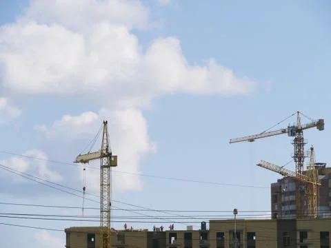 High-rise building under construction with people on the roof Stock Photos