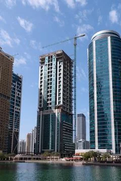 High-rise building under construction with a crane in the JLT district, Dubai Stock Photos