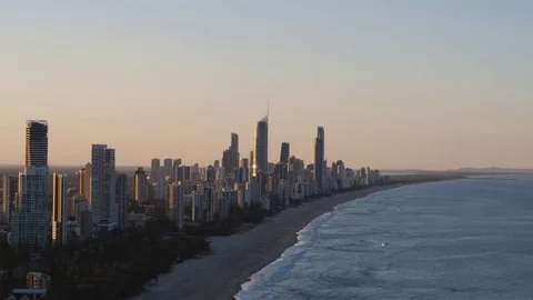 High-rise buildings along the silent sea coast at sunset Stock Footage