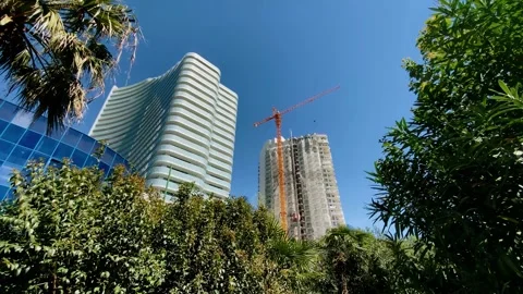 High-rise buildings and a construction crane are operating nearby Stock Footage 334108432