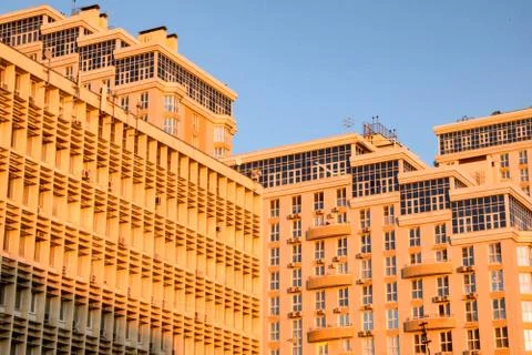 High-rise buildings in the rays of the setting sun. Modern construction of Stock Photos