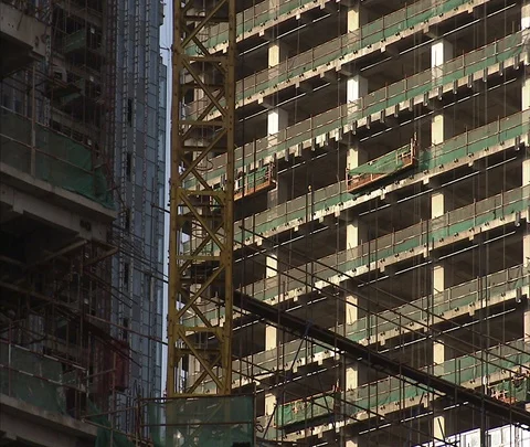 High-rise buildings under construction with scaffolding Stock Footage 86744922