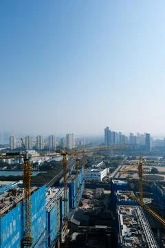 High-rise construction site with cranes in city skyline Stock Photos