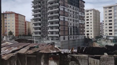 High-rise residential building under construction with scaffolding, showing Stock Footage 333524924