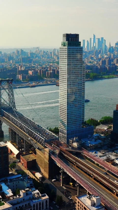 High rise tower beside Williamsburg bridge, East River, New York Vertical video. Stock Footage 342273446