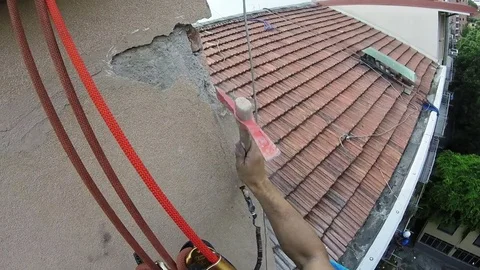 High Rise Worker Restoring Damaged Coat Plaster in House Wall Stock Footage 78447641