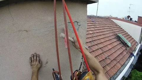 High Rise Worker Restoring Infiltration Scraping External Wall Video stock 78449805