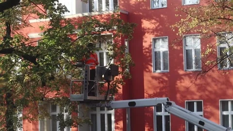 A high-rise worker trims branches on trees Berlin, Germany 10.25.2024 Video stock 312043042