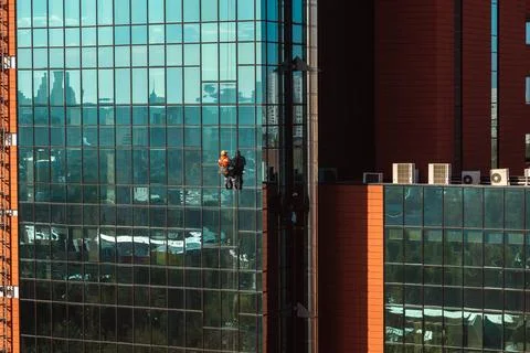 High-rise workers cleaning the windows of a skyscraper Stock Photos