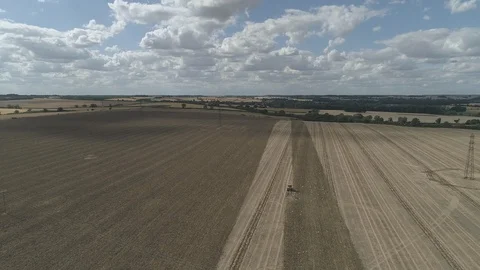 High Rising Shot Using A Drone Of Tractor Ploughing Large Field 4K Resolution Stock Footage 93147773