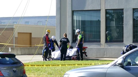 High risk tactical paramedics and firefighters work to help injured worker Video stock 95912875