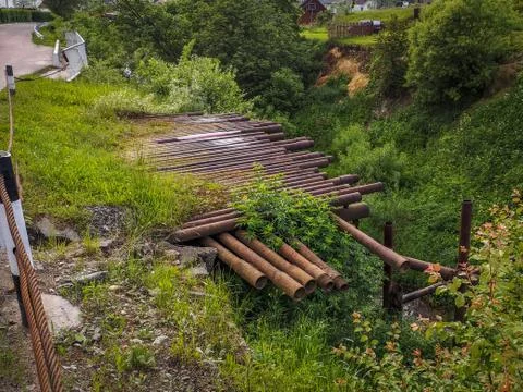 High river hills with old rusty pipes and a road. Foto stock