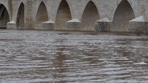 High River Water Flowing Under Stone Bridge After Heavy Rainfall Stock Footage 328219977