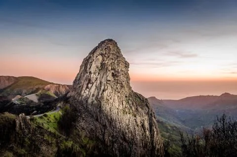 High rock at sunset Stock Photos
