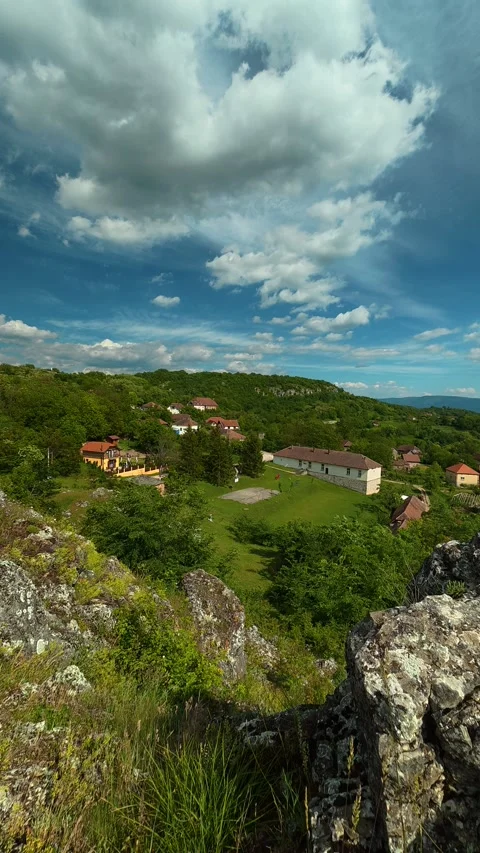High rocks frame a valley view. Vrmdza Lake, Serbia. Vertical Vídeos de archivo 338030426