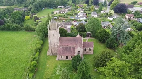 High Rotating Drone Shot Over Bodenham Church Spire with Village Surroundings Stock Footage 281851393