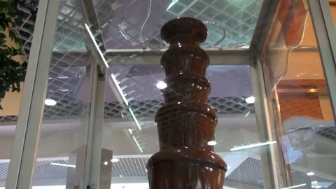 High round conical tower of hot liquid chocolate, which constantly flows down Stock Footage 78702687