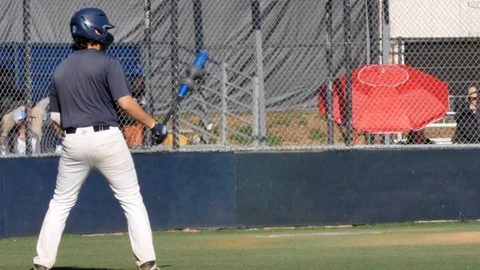 High school baseball batter athlete preparing to bat on sports field Stock Footage 124891155