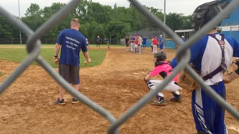 High school baseball catchers trying out for travel baseball program run Stock Footage 104323576