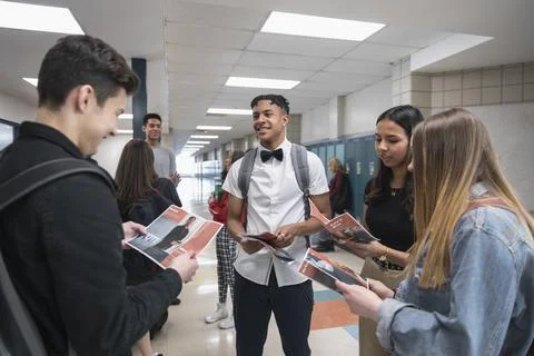 High school boy handing out student body president voting brochures Stock Photos