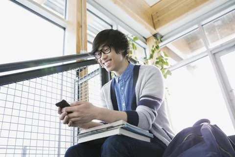 High school boy text messaging with cell phone Stock Photos