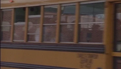 High School Buses pulling out after school session 1990 archival footage Stock Footage 107438956