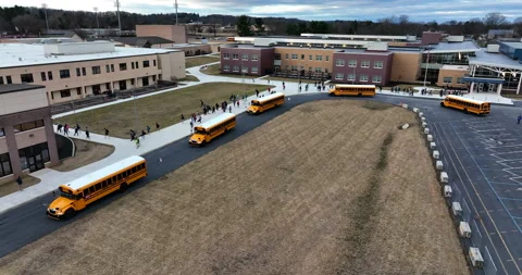 High school campus. Aerial of line up of yellow school bus vehicles. Stock Footage 171861406