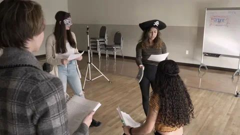 High school drama students with props rehearsing script in studio Stock Footage 221034271