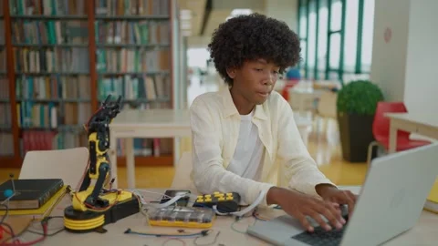 High school female student building, Learning and assembling a robot in library. Stock Footage 320400777